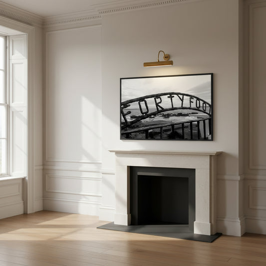 Monochrome seascape photo capturing the serene beauty of the Forty Foot bathing spot in Dublin, Ireland. Martello tower stands in the distance against a clear sky.
