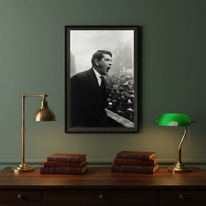 Collector’s Edition framed print of Michael Collins (30×45 cm) hanging above a dark walnut writing desk, leather-bound books, brass desk lamp and green banker’s light, dim lamplight and muted heritage tones.