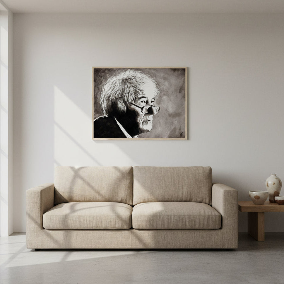 Seamus Heaney with our framed fine art print. The Collector’s Edition print in a natural oak frame hanging above a linen sofa in a minimalist modern home. Pale plaster walls, neutral tones, Irish ceramics and plants nearby. Soft daylight accentuates texture and detail of archival paper.