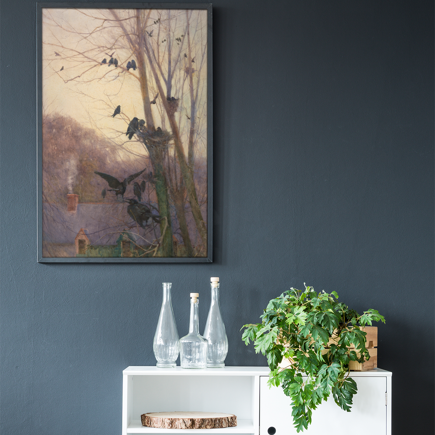White cabinet with decorative items against a dark wall with a framed Irish art print.