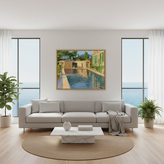 Swimming Pool, Southern France – Sir John Lavery Collector’s Print. Collector’s Edition framed “Swimming Pool, Southern France” above a modern sofa in a bright coastal apartment with big windows, sea-light ambience, minimalist decor.