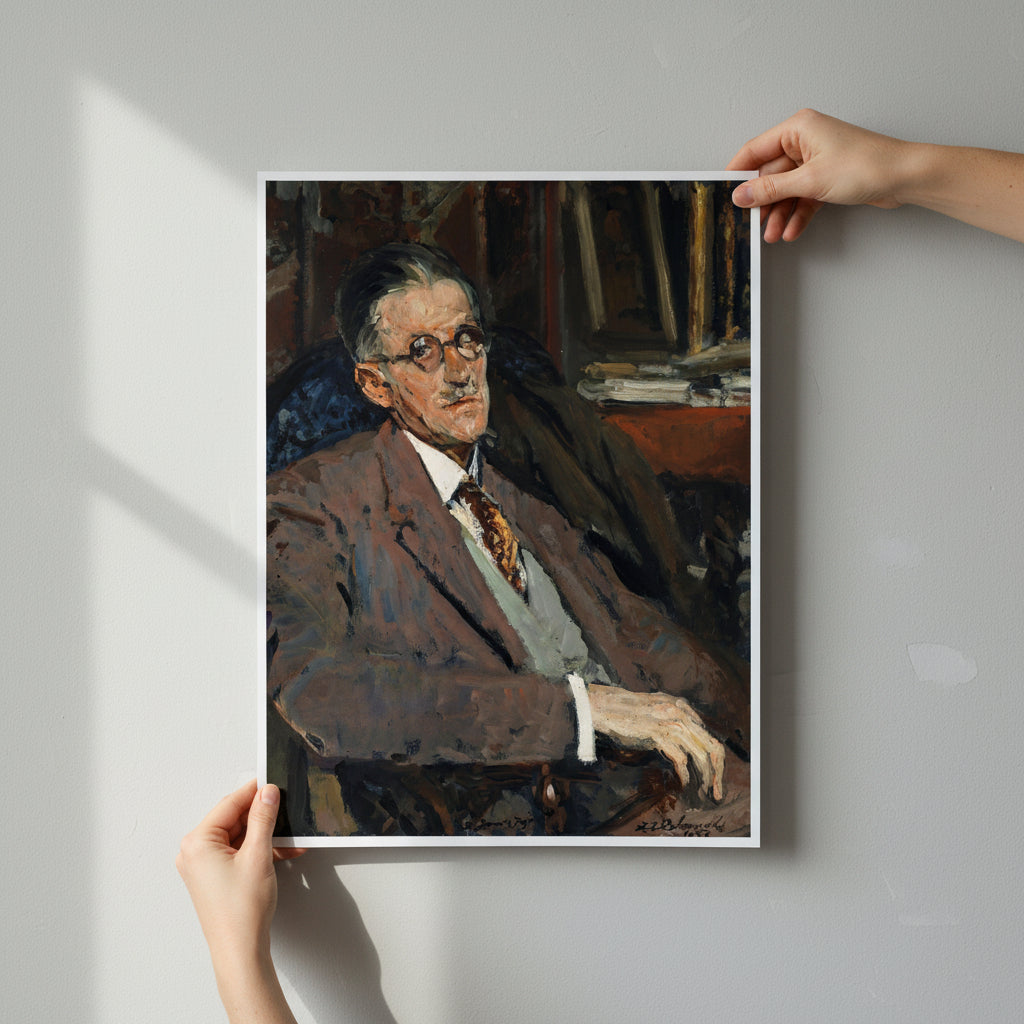Unframed James Joyce portrait print being carefully held by two hands against a neutral wall, no frame, showcasing paper texture, clean editorial style, soft diffused daylight.
