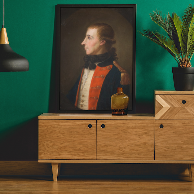 Framed reproduction print of Wolfe Tone in French military uniform, Irish revolutionary leader, Wooden cabinet with decorative items against a green wall