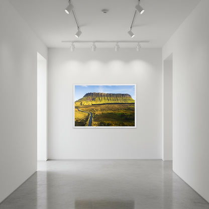 White-framed Benbulben print displayed on a gallery-white wall in a minimalist hallway with spotlight lighting and polished concrete floors.