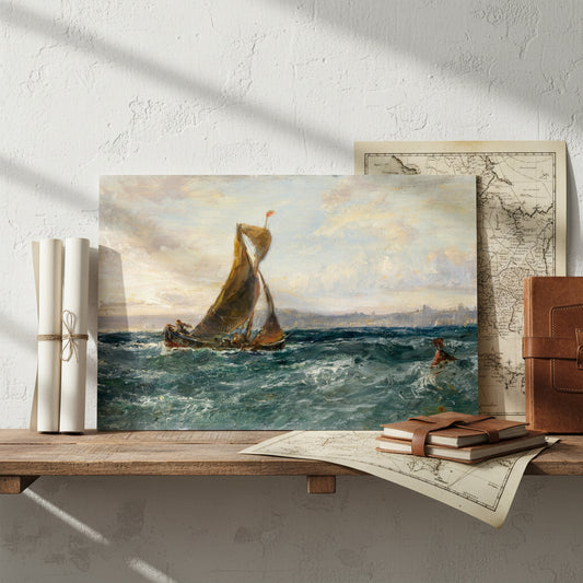 Unframed A View of Dublin Bay print leaning on a studio shelf beside rolled art prints, maritime maps, and sketchbooks; textured plaster wall and soft morning light.