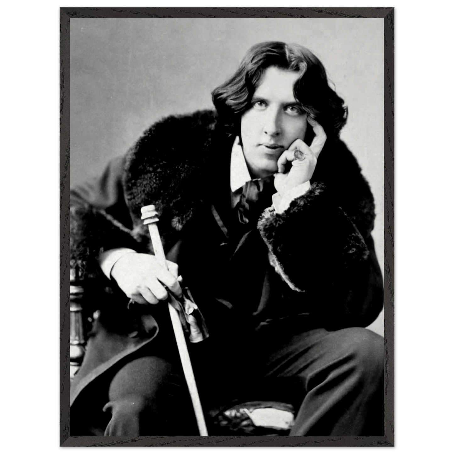 Oscar Wilde vintage portrait displayed in a study or library setting
